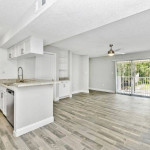 Spacious corner apartment kitchen and den area with modern features and bright natural light.