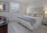 Stylish bedroom in luxury apartment at The Residences at Merrick Park, Coral Gables, featuring elegant decor.