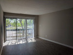 Spacious living room with sliding door and natural light in Tivoli Apartments, Virginia Beach.