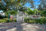 Entrance gate to the pet-friendly dog park surrounded by lush greenery at SoDo Flats apartments in Orlando.