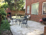 Patio area with seating and barbecue in private backyard of Arlington basement apartment near Clarendon Metro.