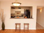 Modern apartment kitchen with bar seating and granite countertop in Jacksonville, FL.