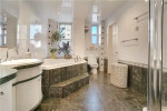 Spacious bathroom with modern fixtures, natural light, and elegant design in Brooklyn apartment.