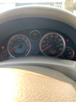 Dashboard view of a 2006 Infiniti G35 Coupe showing gauges and indicators.