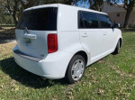 2008 Scion xB hatchback in white, showcasing its clean design and efficient 4-cylinder engine.
