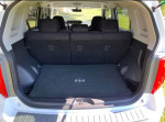 Interior view of 2008 Scion xB hatchback trunk with clean carpet and folded seats.