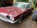 1966 Ford Thunderbird with new parts, parked outdoors, showing wear and history.