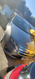 2010 Ford Fusion in gray, showing exterior and open door, ideal for students and daily use.