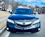 2014 Acura RDX front view showcasing sleek design and clean appearance in a residential area.