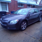 2011 Chevrolet Malibu in excellent condition with 99,000 miles parked on driveway.