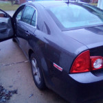 2011 Chevrolet Malibu in excellent condition with 99,000 miles, showcasing rear and side view.