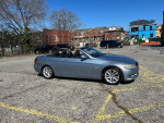 2000 BMW 3 Series 328i convertible parked, showcasing sleek design and clean exterior under clear skies.
