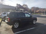 2012 Jeep Patriot 4x4 parked with roof rack, showcasing its clean frame and body in Newburgh.