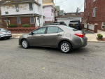 Side view of a 2017 Toyota Corolla LE with 139k miles in a residential area