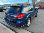 2011 Subaru Outback in blue, parked with a clean exterior and tinted windows, showcasing its all-wheel drive features.