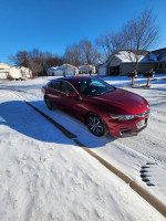 2018 Chevrolet Malibu LT in red parked on snowy driveway, showcasing its low mileage and excellent condition.