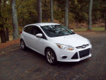 2013 Ford Focus SE Hatchback in excellent condition with 70,000 miles, parked in a scenic setting.