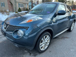 2013 Nissan Juke SV in gray, featuring AWD, navigation, backup camera, and clean Carfax, parked outside.