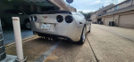 2006 Chevrolet Corvette C6 Z51 from rear, showcasing its sleek design and custom exhaust system.