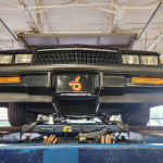 Underside view of a Buick Grand National with visible suspension upgrades and T-top design.