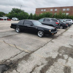 1985 Buick Grand National with T-tops, upgraded suspension, and original paint parked in a lot.