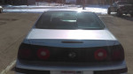 Rear view of a silver 2001 Chevy Impala, showcasing its clean design and excellent condition.