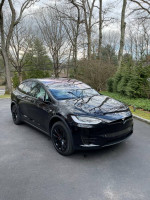 2016 Tesla Model X P100D fully loaded with unlimited supercharging, black exterior, parked in a driveway