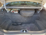 Trunk space of a 2001 Ford Crown Victoria showing items like tools and spare parts.