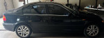 2002 BMW 3 Series 330xi AWD parked in garage, featuring sleek black exterior and alloy wheels.