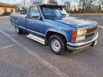1991 Chevy Silverado C1500 pickup truck in blue with an 8-foot bed, parked on a lot.