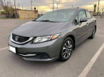 Gray Honda Civic parked with clean title, good tires, and reverse camera, ideal for fuel efficiency.
