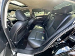 Interior view of a black Infiniti Q50 sedan showcasing luxurious leather seats and spacious back seat area.