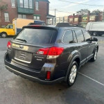 Rear view of a 2013 Subaru Outback 2.5i parked, showing its clean lines and compact SUV design