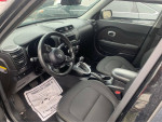 Interior view of a 2015 Kia Soul featuring black seats and modern dashboard design.