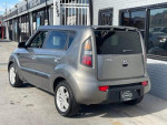 2010 Kia Soul in Titanium exterior color, featuring 100,355 miles and front-wheel drive, parked outside a dealership.