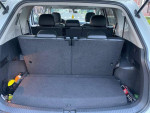 Interior view of the 2018 Volkswagen Tiguan SUV with seats folded down, showcasing spacious cargo area.