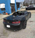 Black 2017 Chevrolet Camaro SS convertible parked outside, showcasing its aggressive styling and sporty design.