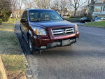 2007 Honda Pilot EX-L FWD in good condition, parked on the street with clear exterior and well-maintained interior