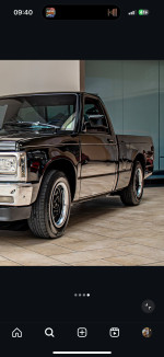 1992 Chevrolet S-10 Tahoe truck with shiny black exterior and chrome wheels, showcasing excellent condition.
