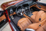 Interior of 2020 BMW M850i xDrive with Cognac Merino leather and advanced infotainment system.