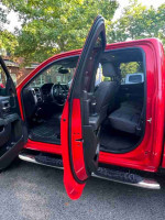 Interior view of a 2015 Chevrolet Silverado 1500 High Country with open doors.