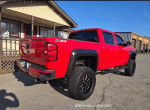 2016 Chevrolet Silverado 1500 Rocky Ridge with aggressive off-road upgrades, parked outside with sunny backdrop.