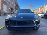 Front view of a 2015 Porsche Macan S AWD, showcasing its sleek design and headlights.
