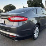 Gray 2015 Ford Fusion with reverse camera and clean title, perfect for gas savings and daily commuting.