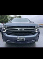 Front view of a 2021 Chevrolet Suburban LS with sleek design and modern grille, showcasing its powerful presence.