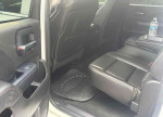 Interior view of 2014 GMC Sierra 1500 showing spacious backseat with leather seating and floor mat