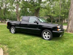 2003 Chevrolet Silverado 1500 SS on grass, showcasing its sporty design and performance features.