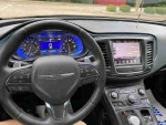 Interior view of a 2016 Chrysler 200S with blue leather seats and advanced navigation system.