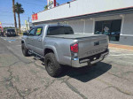 2016 Toyota Tacoma Double Cab in silver color, rear view, parked in North Las Vegas with for sale sign