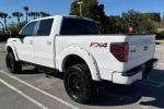 2013 Ford F-150 FX4 in white, showcasing a powerful V8 engine and off-road enhancements.